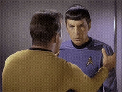 Two Men Standing Next to Each Other One Wearing Star Trek Shirt