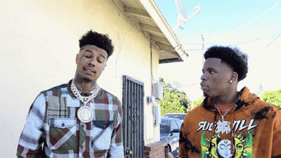 Two Men Standing Next To Each Other One Wearing Sue Will Hoodie GIF