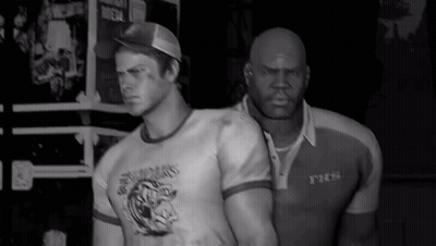 Two Men Standing Next To Each Other One Wearing YTCS Shirt GIF