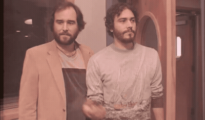 Two Men Standing Next To Each Other One With Beard GIF