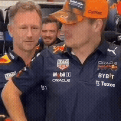 Two Men Standing Next To Each Other One With Hat GIF