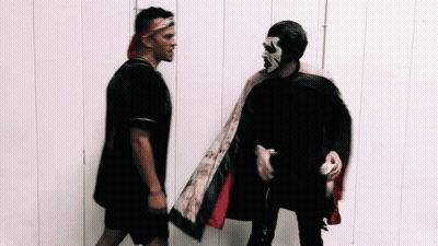 Two Men Standing Next To Each Other GIF