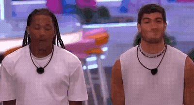 Two Men Standing Next To Each Other GIF