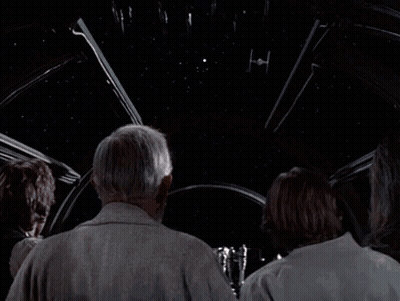Two Men Standing Next To Each Other Saying Its Too Big To Be A Space Station GIF