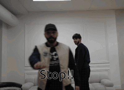 Two Men Standing Next To Each Other Saying Stop GIF