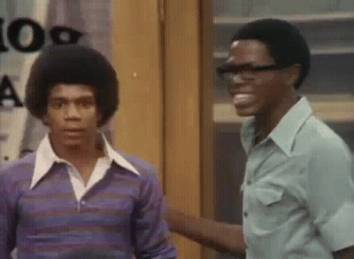 Two Men Standing Next To Each Other Smiling GIF