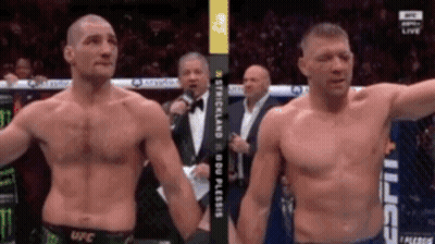 Two Men Standing Next To Each Other GIF