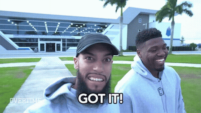Two Men Standing Next To Each Other GIF