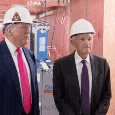 Two Men Standing Next To Each Other Wearing Hard Hats With A Poop On Them GIF