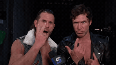 Two Men Standing Next To Each Other With A Microphone That Says U. GIF