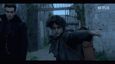 Two Men Standing Next To Each Other With A Netflix Logo On The Bottom GIF