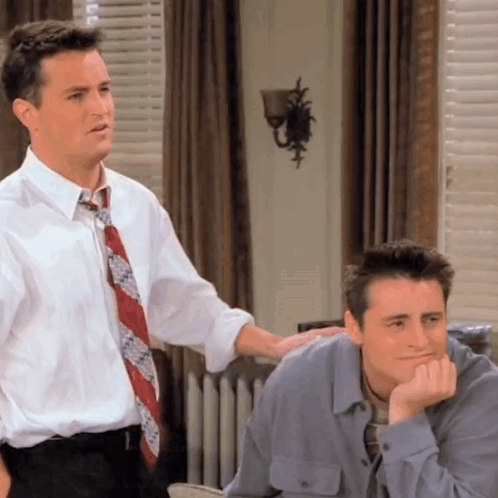 Two Men Standing Next To Each Other With Hand On Shoulder GIF