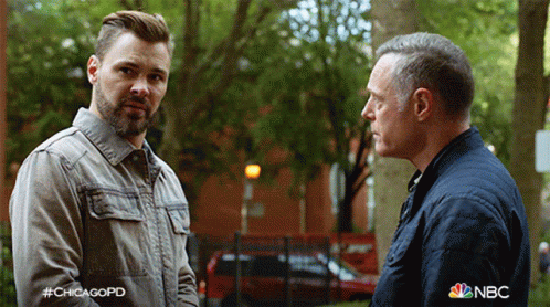 Two Men Standing Next To Each Other With NBC Logo GIF