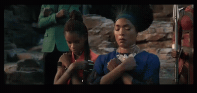 Two Men Standing Next To Each Other With One Wearing A Blanket That Says ' Mt ' On It GIF