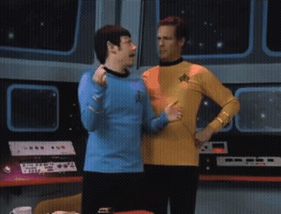 Two Men Standing Next To Each Other With One Wearing A Blue Shirt With A Star Trek Logo On It GIF