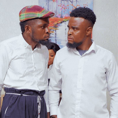 Two Men Standing Next To Each Other With One Wearing A Plaid Hat And The Other Wearing White Shirts GIF