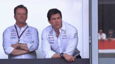 Two Men Standing Next To Each Other With One Wearing A Shirt That Says Ineos On It GIF