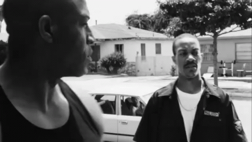Two Men Standing Next To Each Other With One Wearing A Shirt That Says ' South Side ' On The Front GIF
