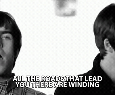 Two Men Standing Next To Each Other With The Words " All The Roads That Lead You There Are Winding " Above Them GIF