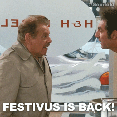 Two Men Standing Next To Each Other With The Words Festivus Is Back On The Bottom GIF