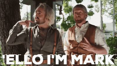 Two Men Standing Next To Each Other With The Words " Hello I 'M Mark " Written In White GIF