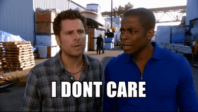 Two Men Standing Next To Each Other With The Words " I Dont Care " On The Bottom Right GIF