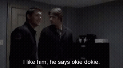 Two Men Standing Next To Each Other With The Words I Like Him He Says Okie Dokie GIF