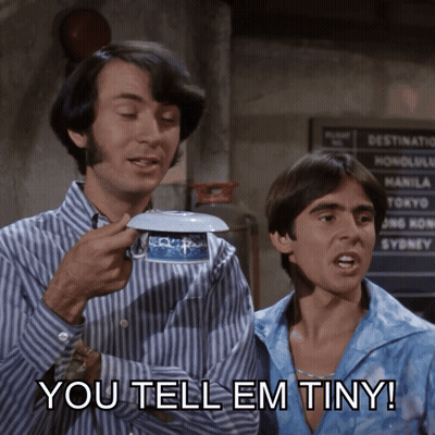 two men standing next to each other with the words you tell em tiny on the bottom right