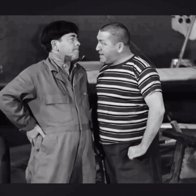 Two Men Standing Next To Each Other With Their Hands In Their Pockets GIF