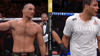 Two Men Standing Next To Each Other GIF