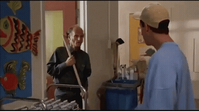 Two Men Standing Next To Fish On Wall GIF