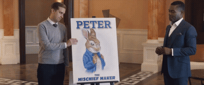 Two Men Standing Next To Peter The Mischief Maker Poster GIF