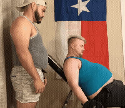 Two Men Standing Next To Texas Flag GIF