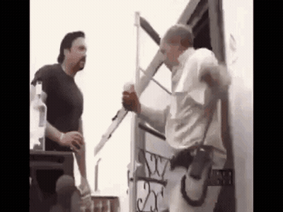 Two Men Standing Next To Trailer GIF