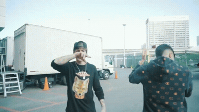 Two Men Standing Next To Truck GIF