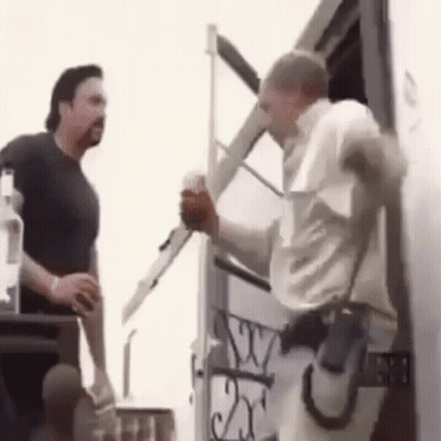 Two Men Standing Next To White Truck GIF