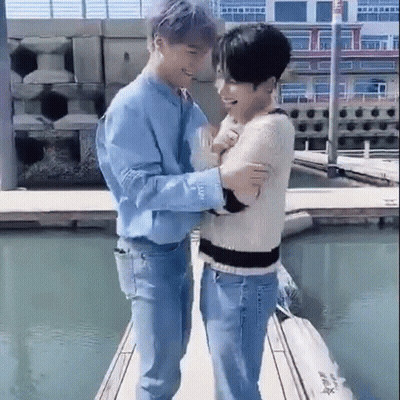 Two Men Standing On A Dock GIF