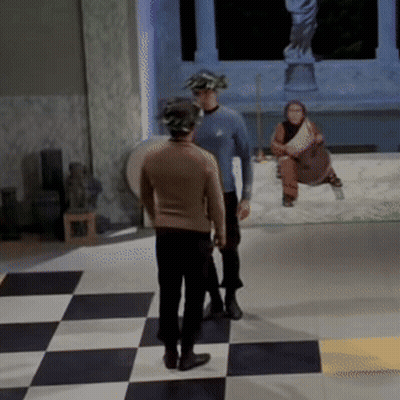 Two Men Standing On Checkered Floor GIF
