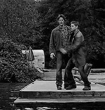 Two Men Standing On Dock By River GIF