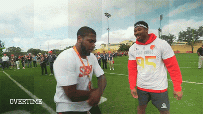 Two Men Standing On Field GIF
