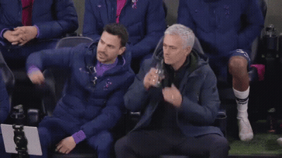 Two Men Standing On Soccer Field Talking GIF