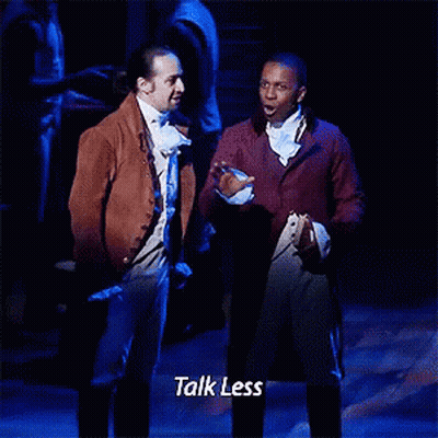 Two Men Standing On Stage Talking GIF
