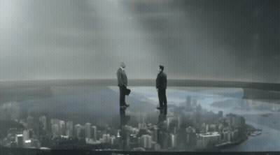 Two Men Standing On Top Of A Bridge Overlooking A City Skyline GIF