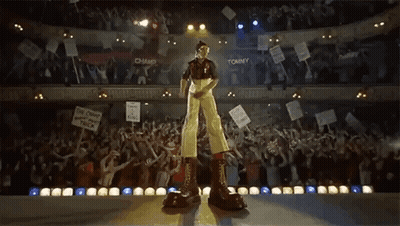 Two Men Standing On Track With Arms In Air GIF