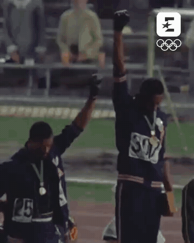 Two Men Standing On Track With Arms In Air GIF