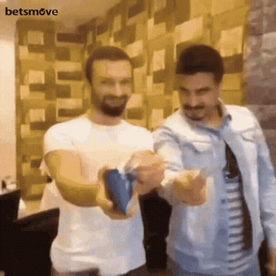 Two Men Standing One Holding Blue Object GIF