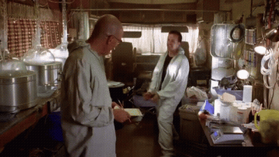 Two Men Standing One Holding Paper GIF