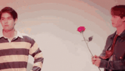 Two Men Standing One Holding Rose GIF