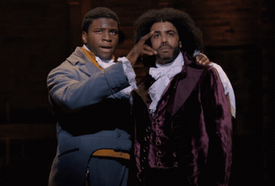 Two Men Standing One in Purple Jacket