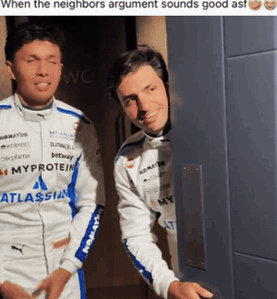 Two Men Standing, One Wearing Atlassian Jacket GIF